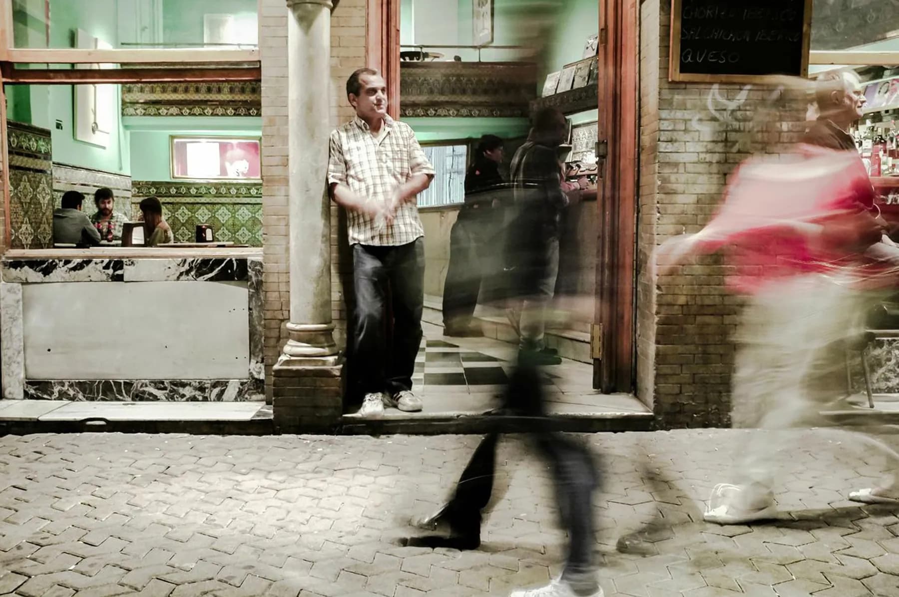 A Seville city-centre street at dusk, warmly lit